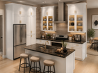 White shaker kitchen with island and glass doors